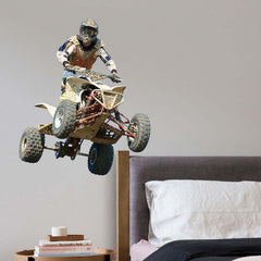 36 inch competitor jumping a quad decal installed above bed and nightstand